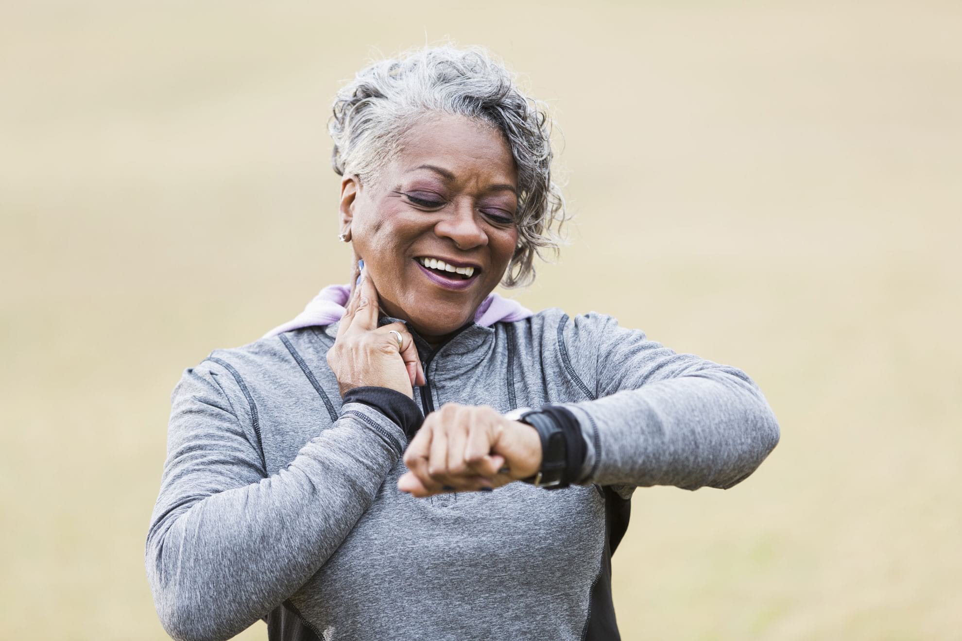 Woman exercising and checking heart rate.