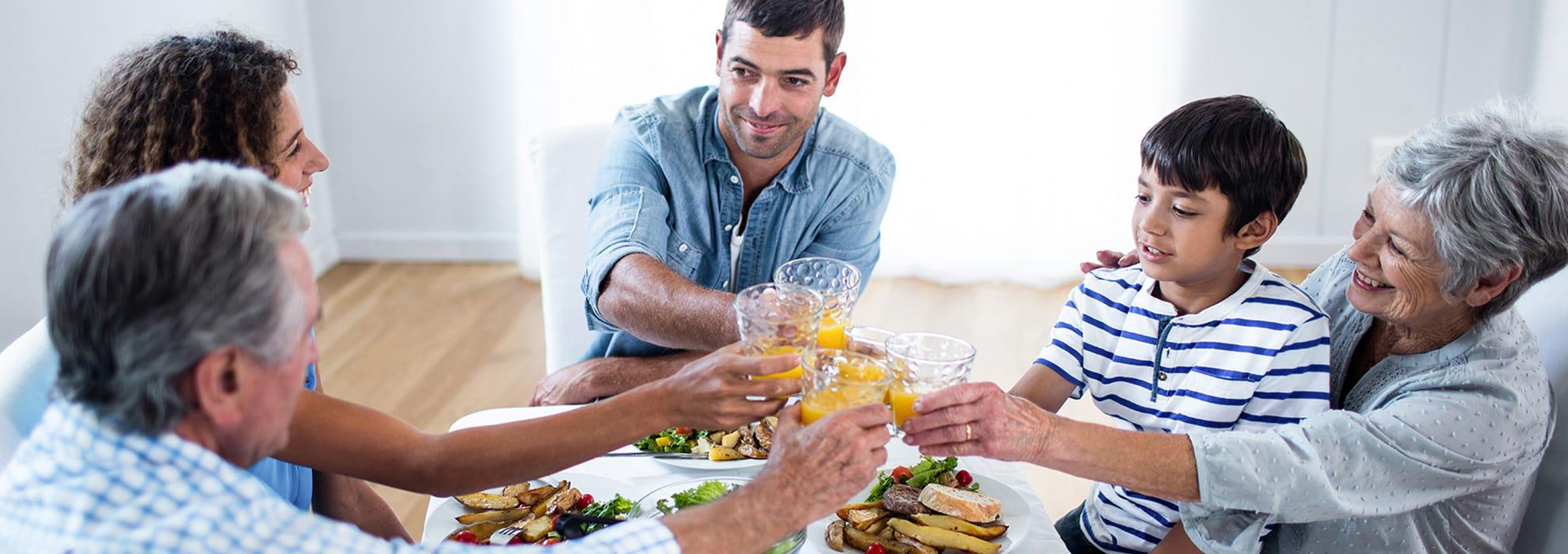 Generational family eating at table.