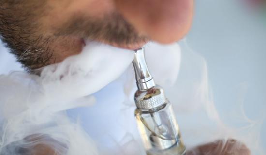 Man vaping using an e-cigarette 