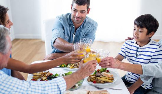 Generational family eating at table.