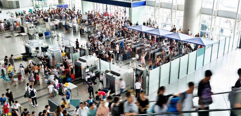 People gathering for an event in open building hall.